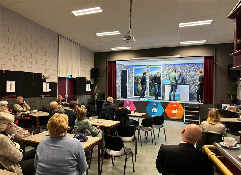 Het levende spel Catan tijdens de participatieavond. Initiatiefnemers gingen in gesprek met de gemeente. De bewoners zitten in het publiek.
